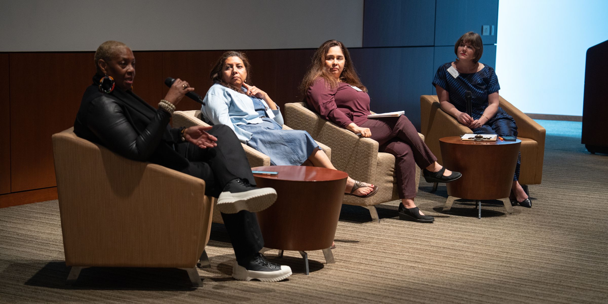 Panel of four women in chairs talking