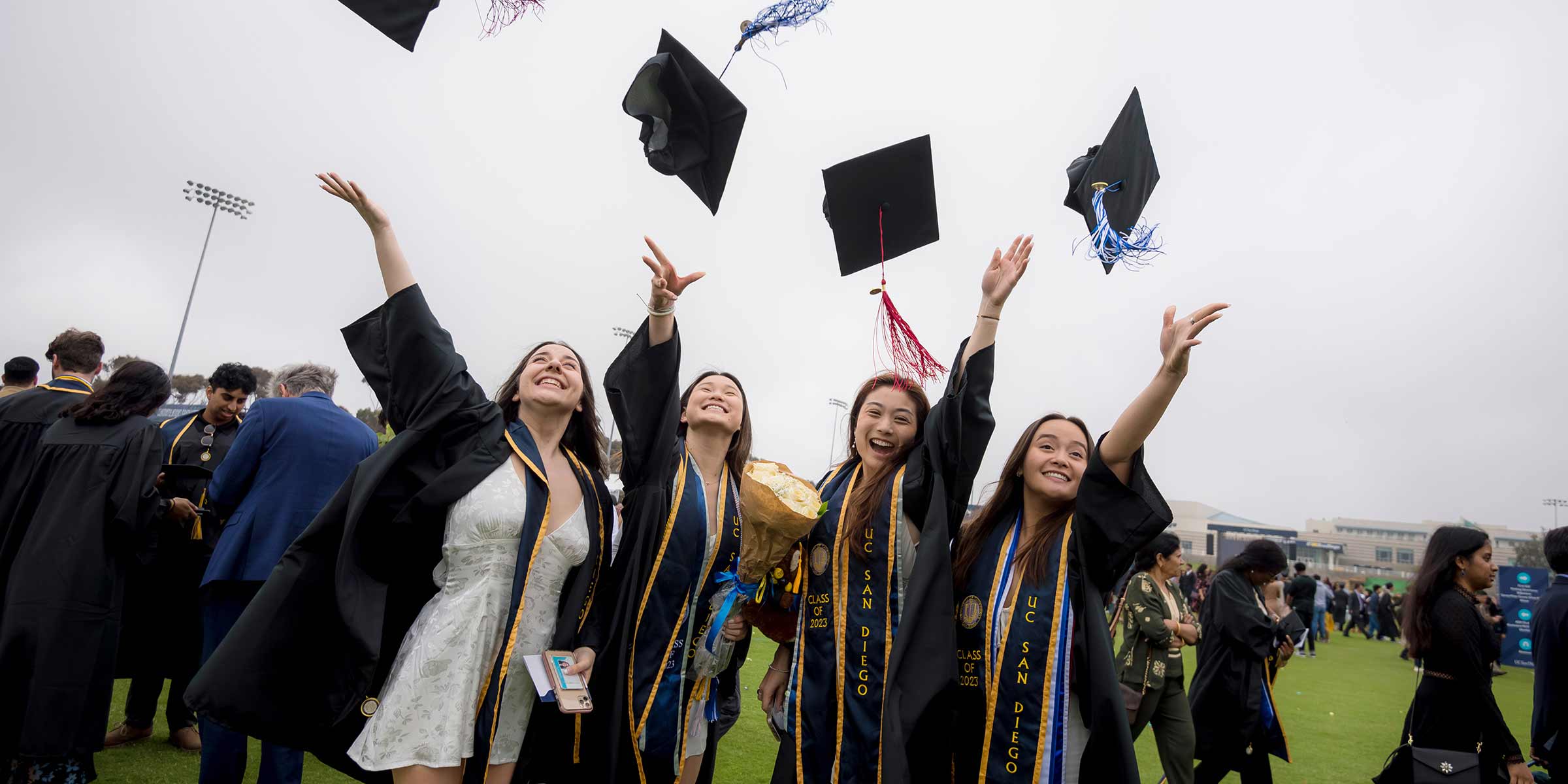 Students throw their graduation caps following the All Campus Commencement