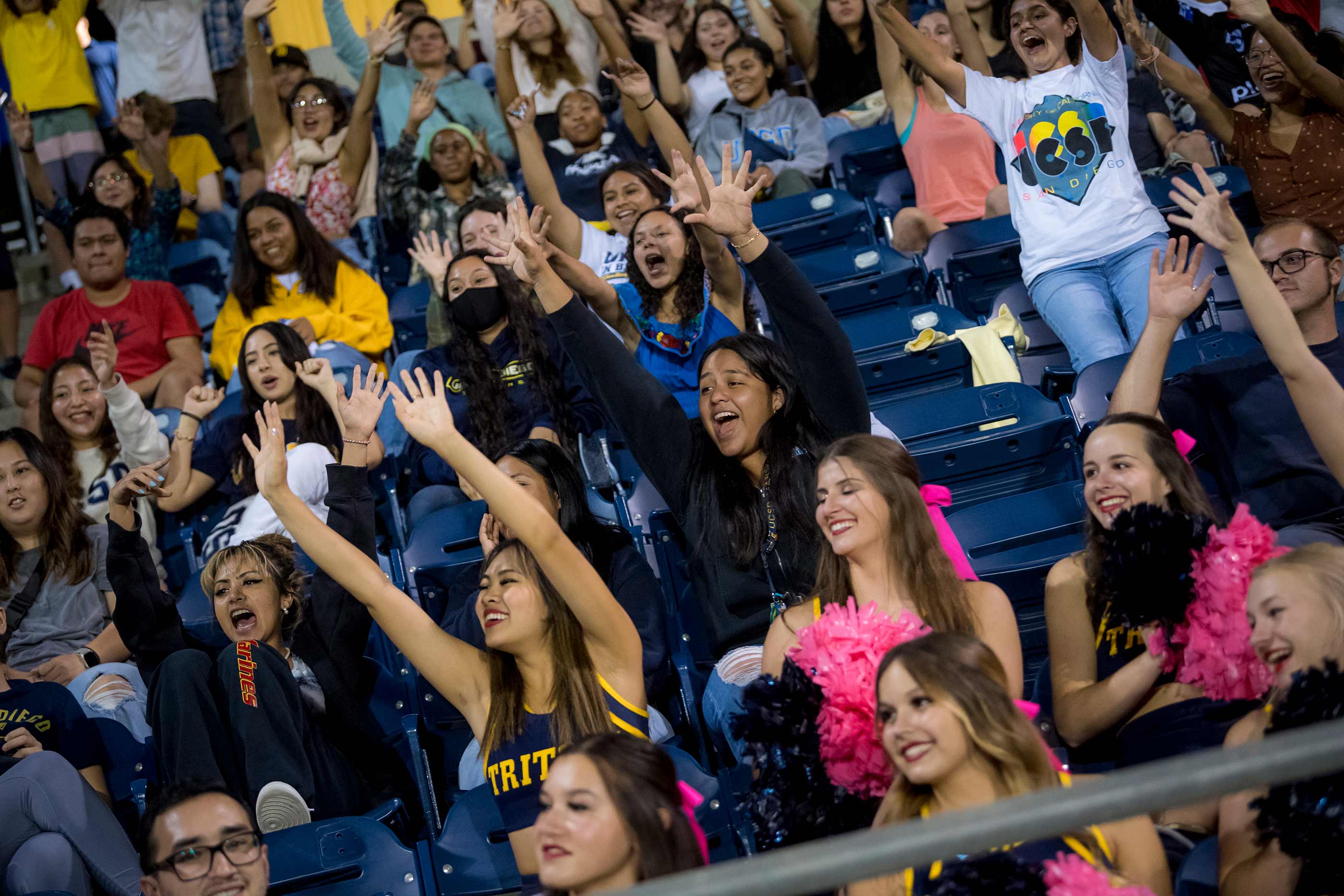 Students cheer at the men's soccer match