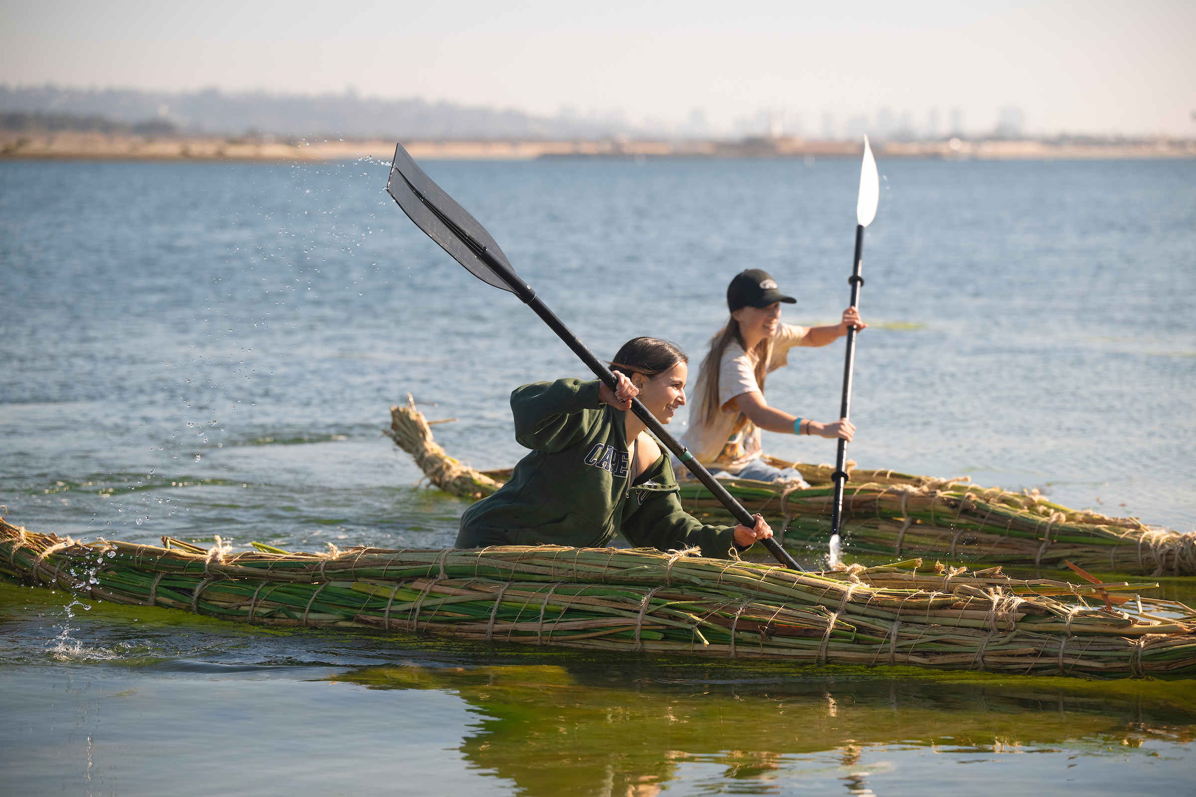 Students race on tule boats