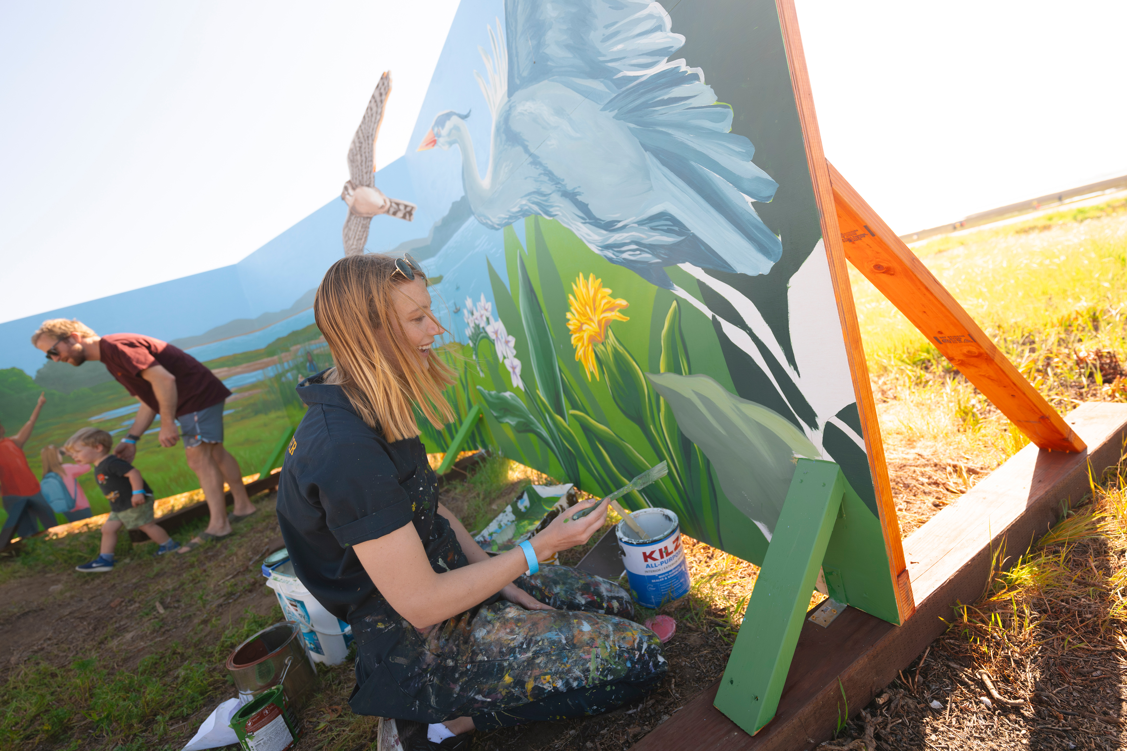 Artist working on mural.