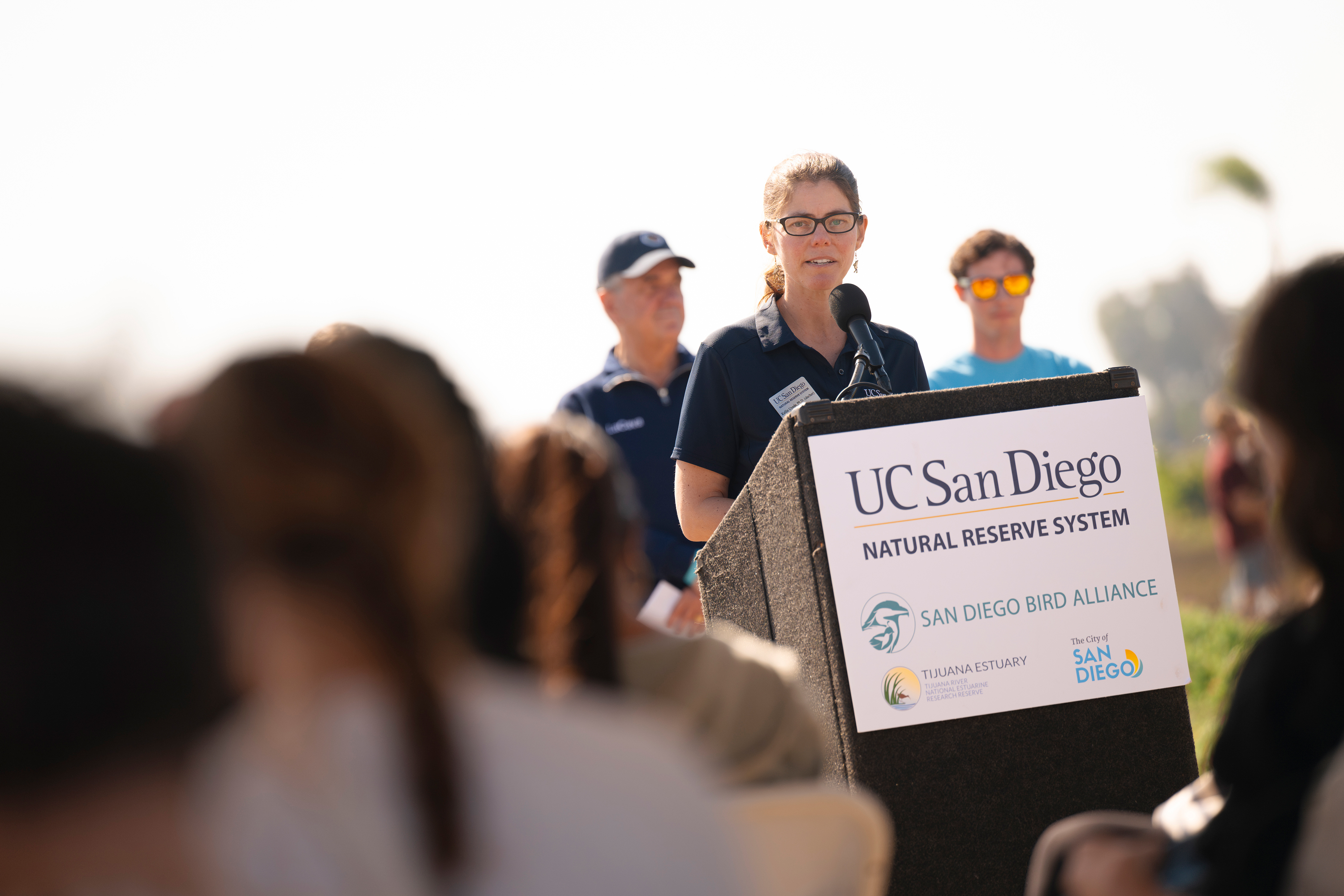 Woman stands at podium