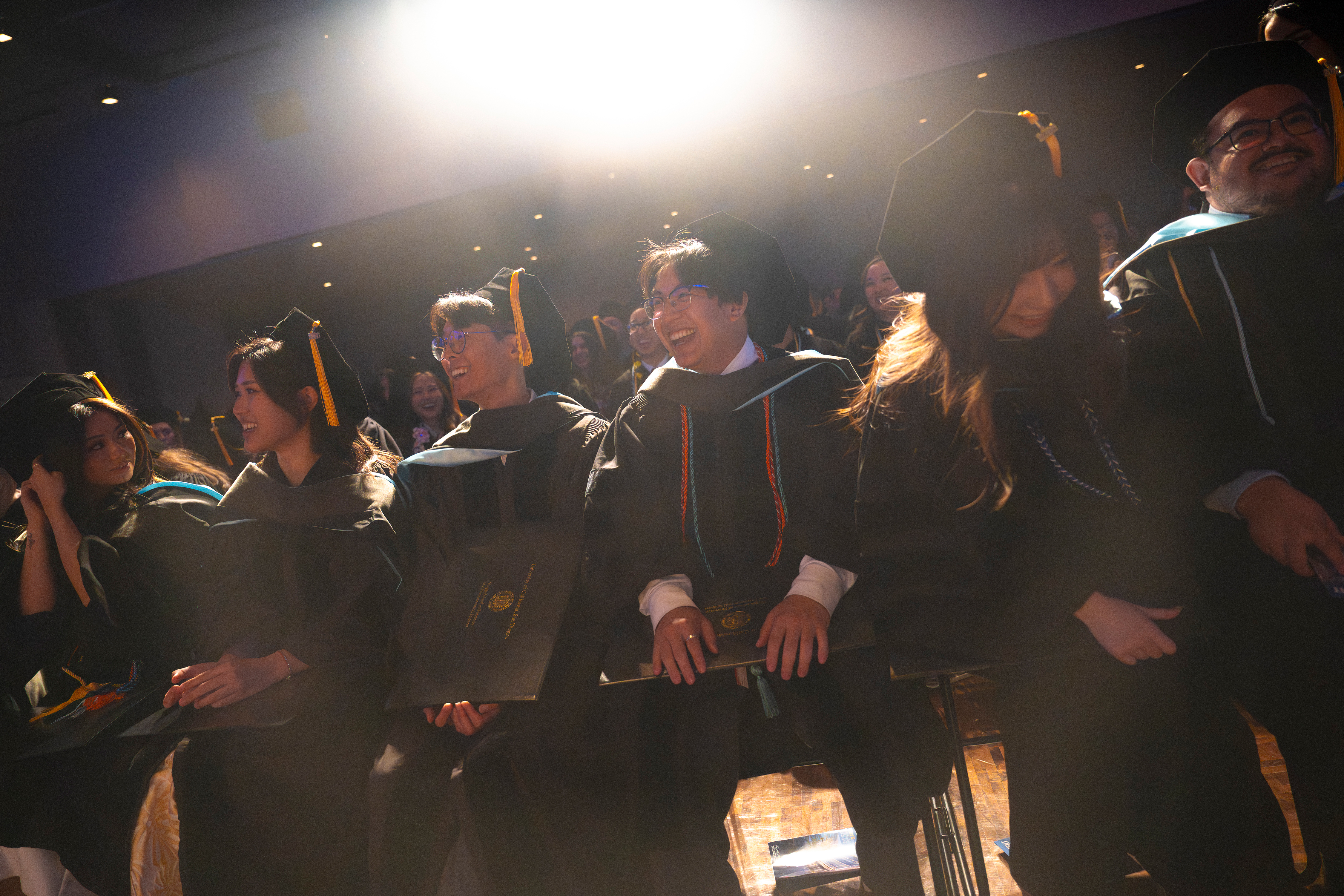 Students laughing and cheering while they are seated in the auditorium.