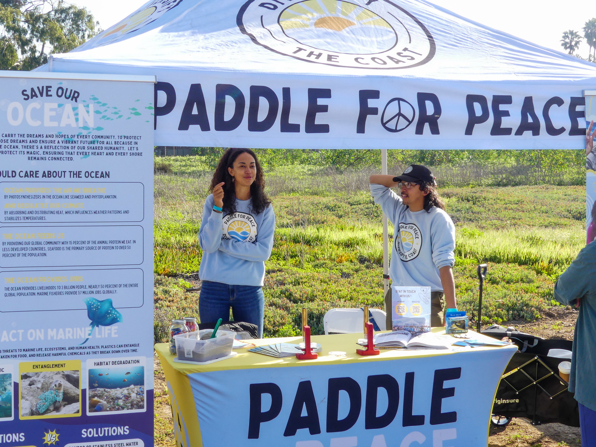 Two people stand at booth