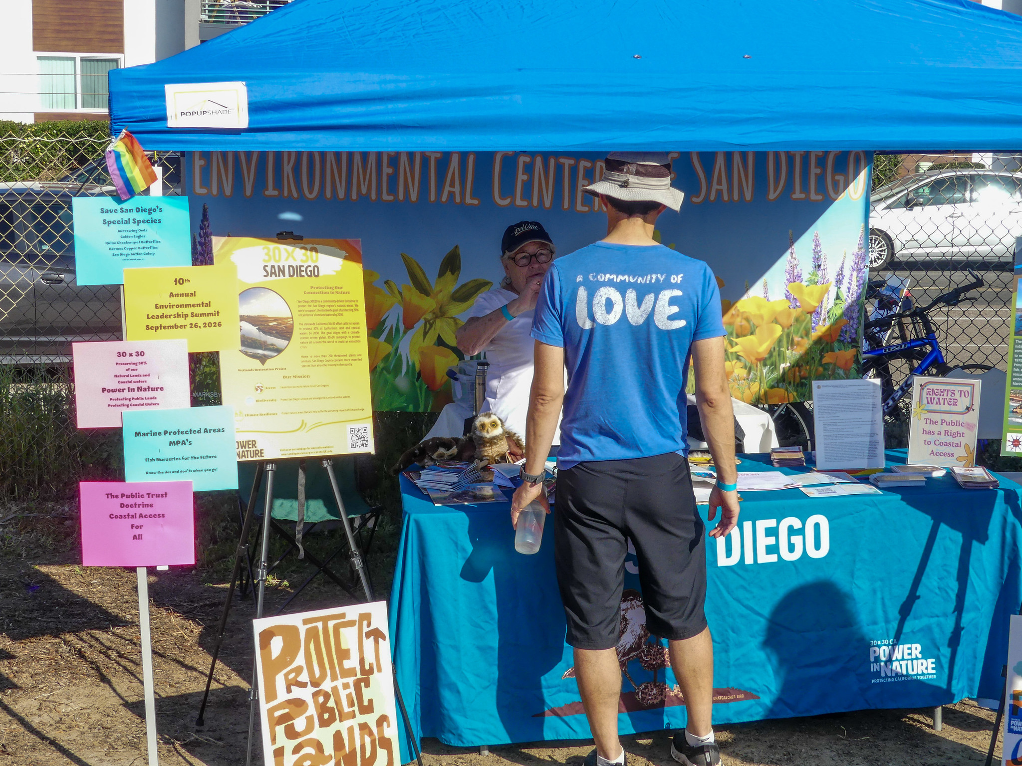 Visitor stands at booth