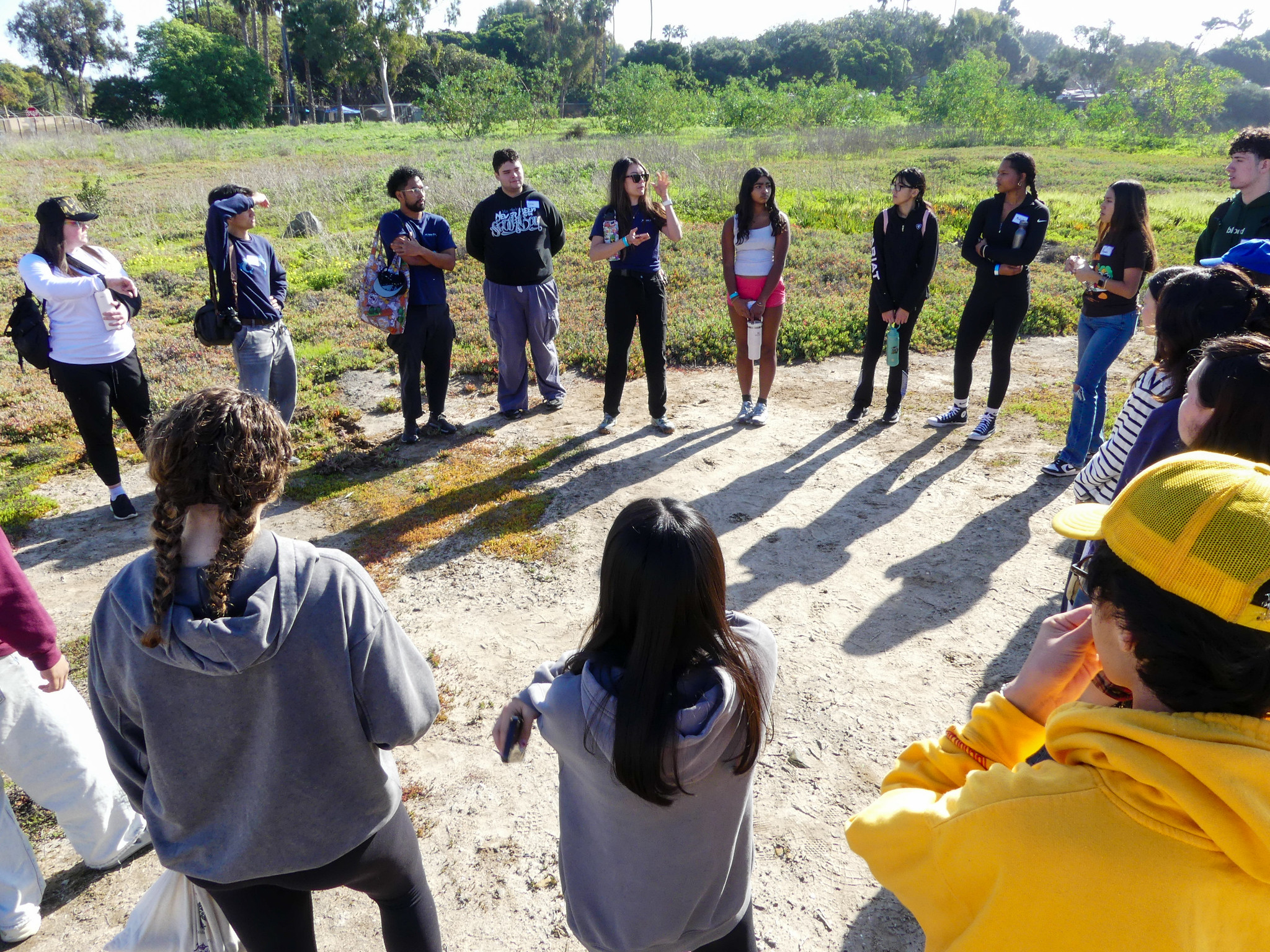 Group of people stand in circle