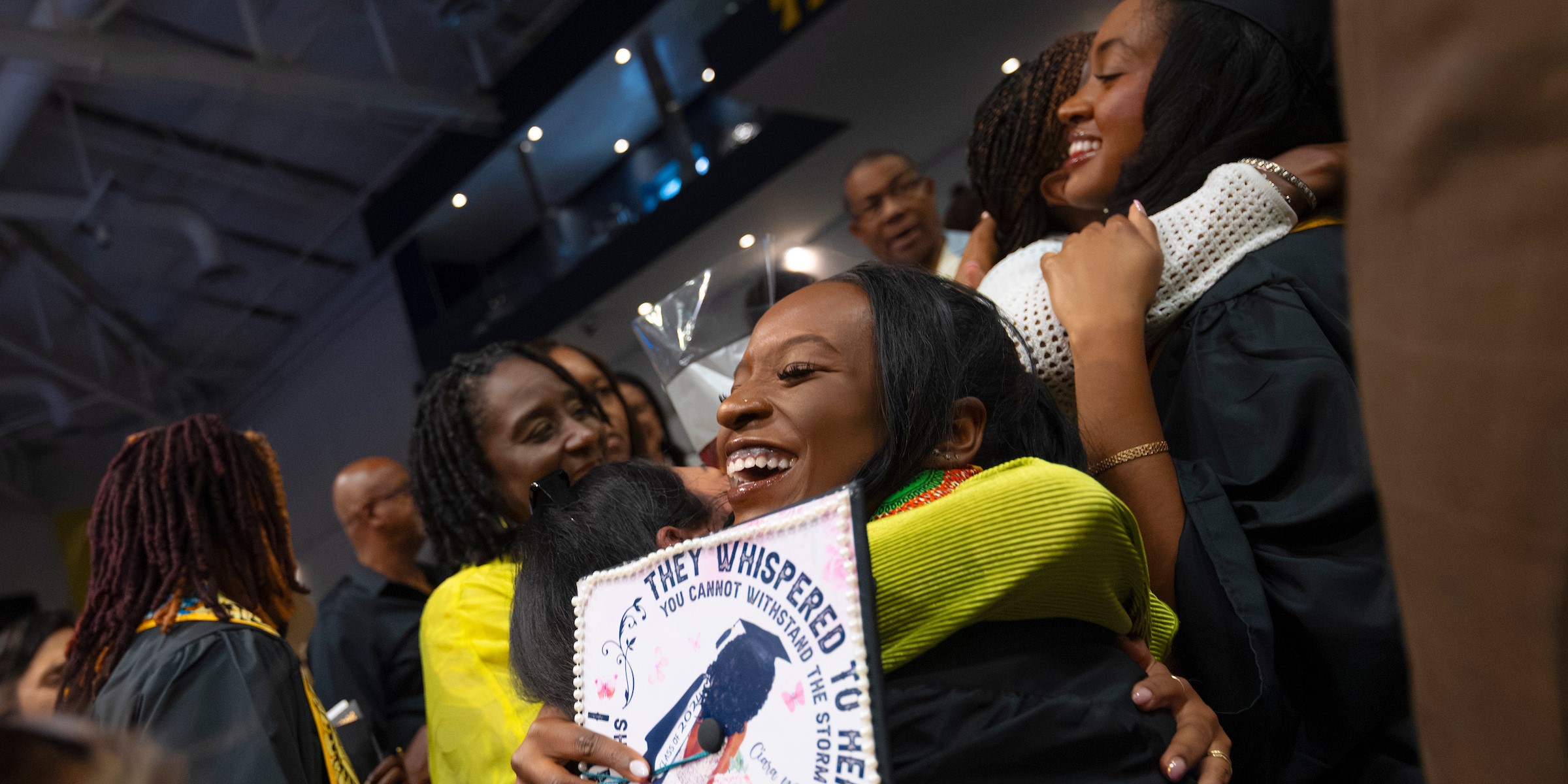 A graduate hugging a loved one