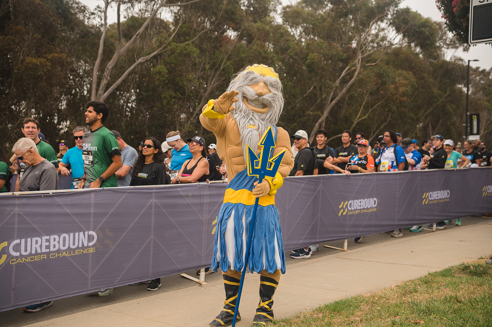 King Triton mascot waves at camera