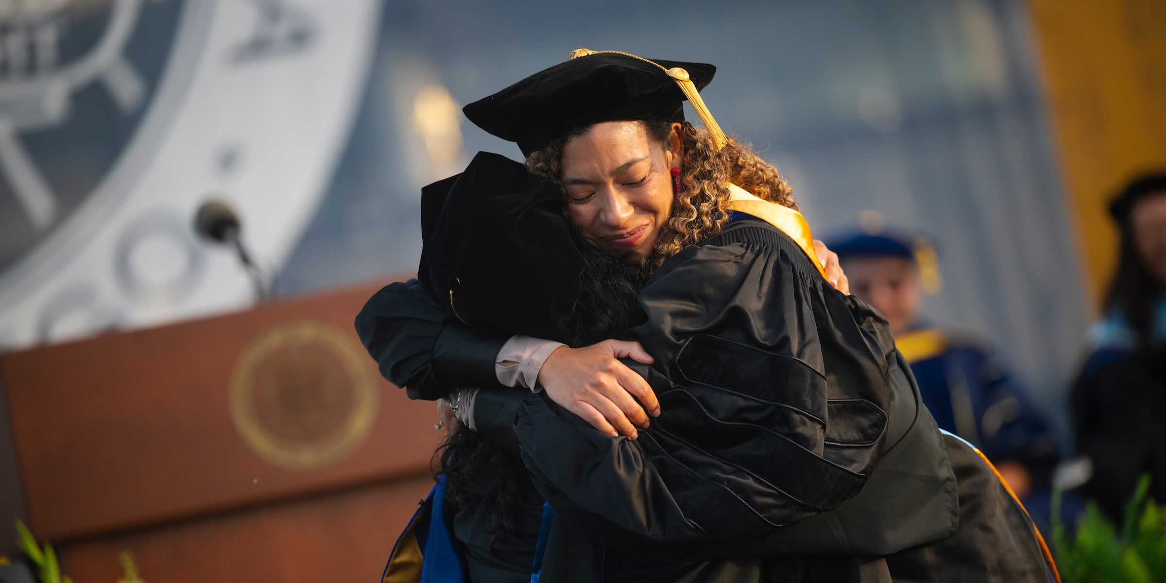 Two scholars hugging