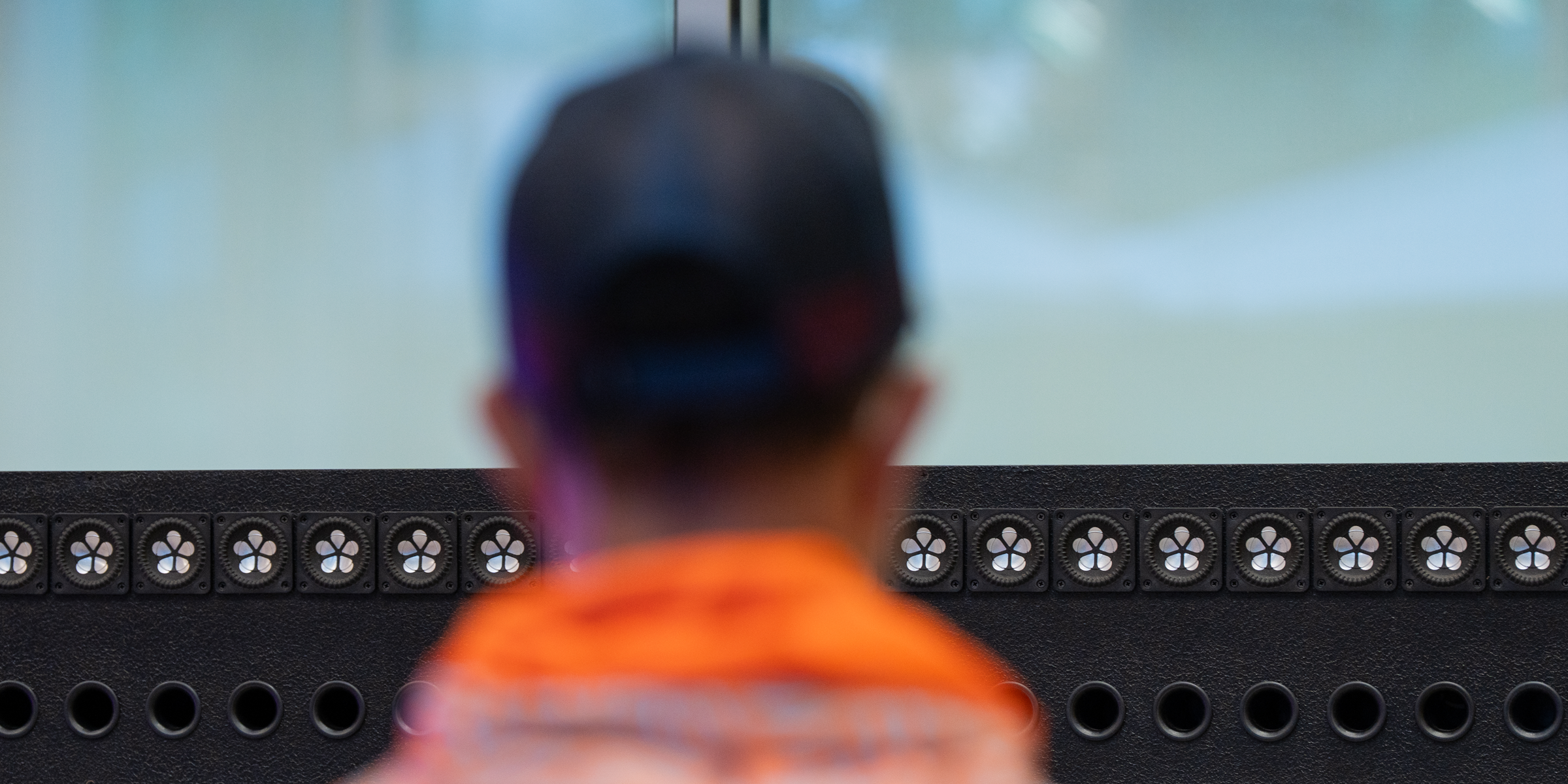 A person stands in front of a sound hologram speaker
