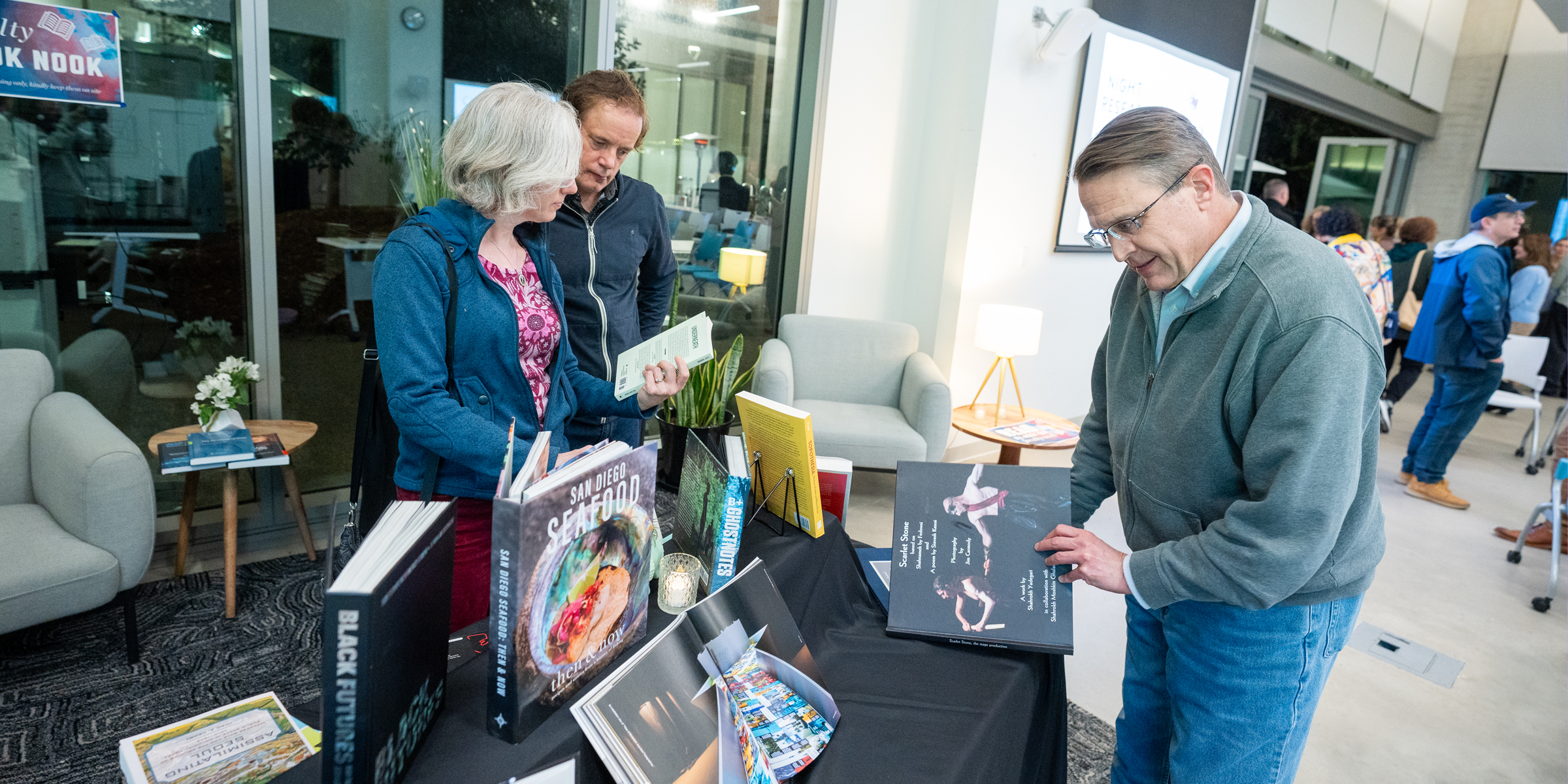 Visitors browse books by faculty