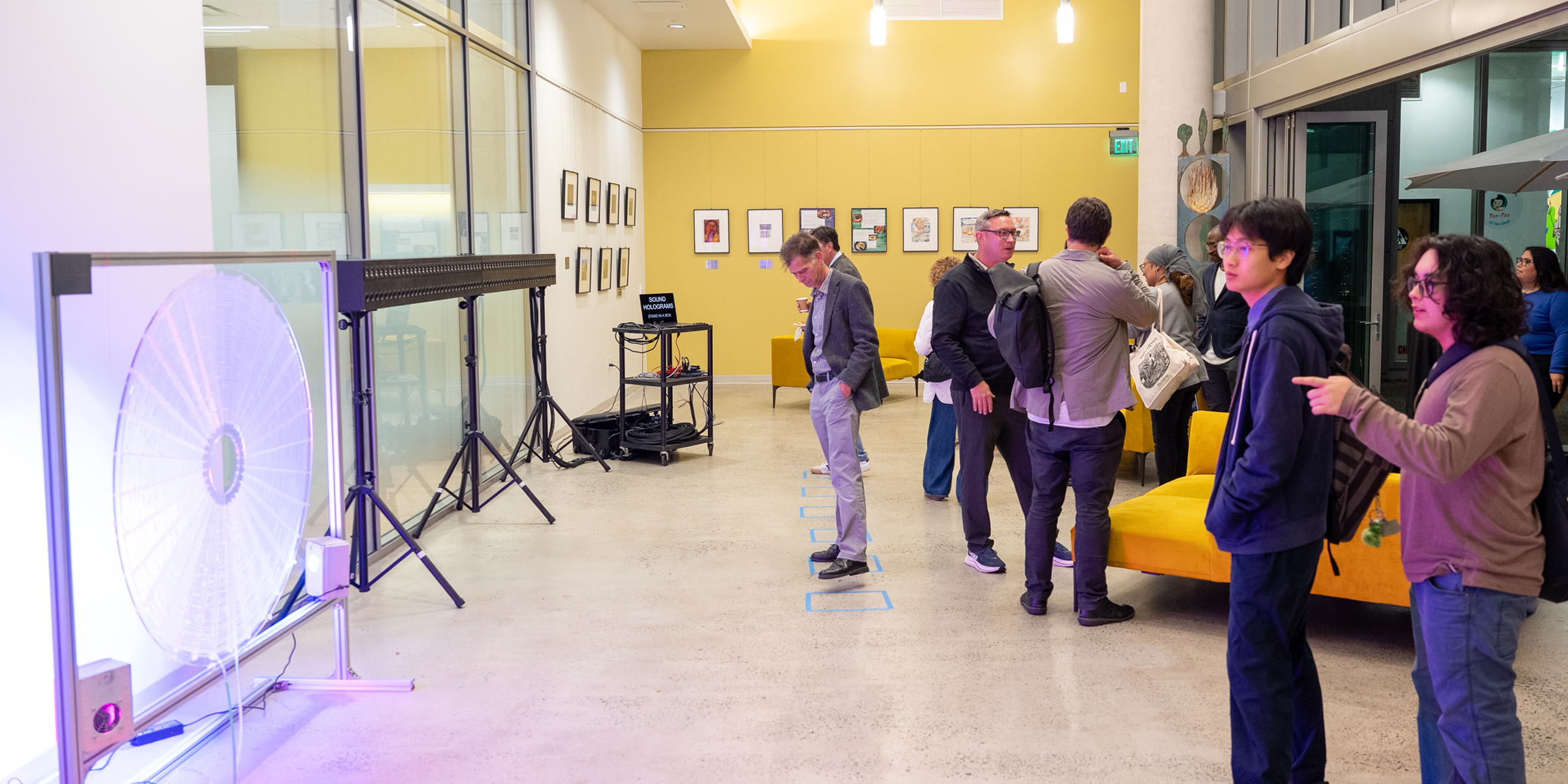 Several visitors explore art installations