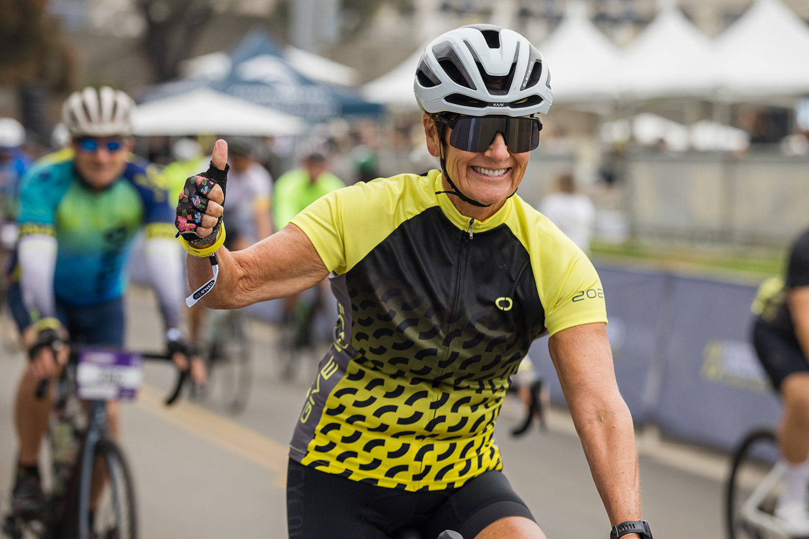 cyclist gives thumbs up while riding