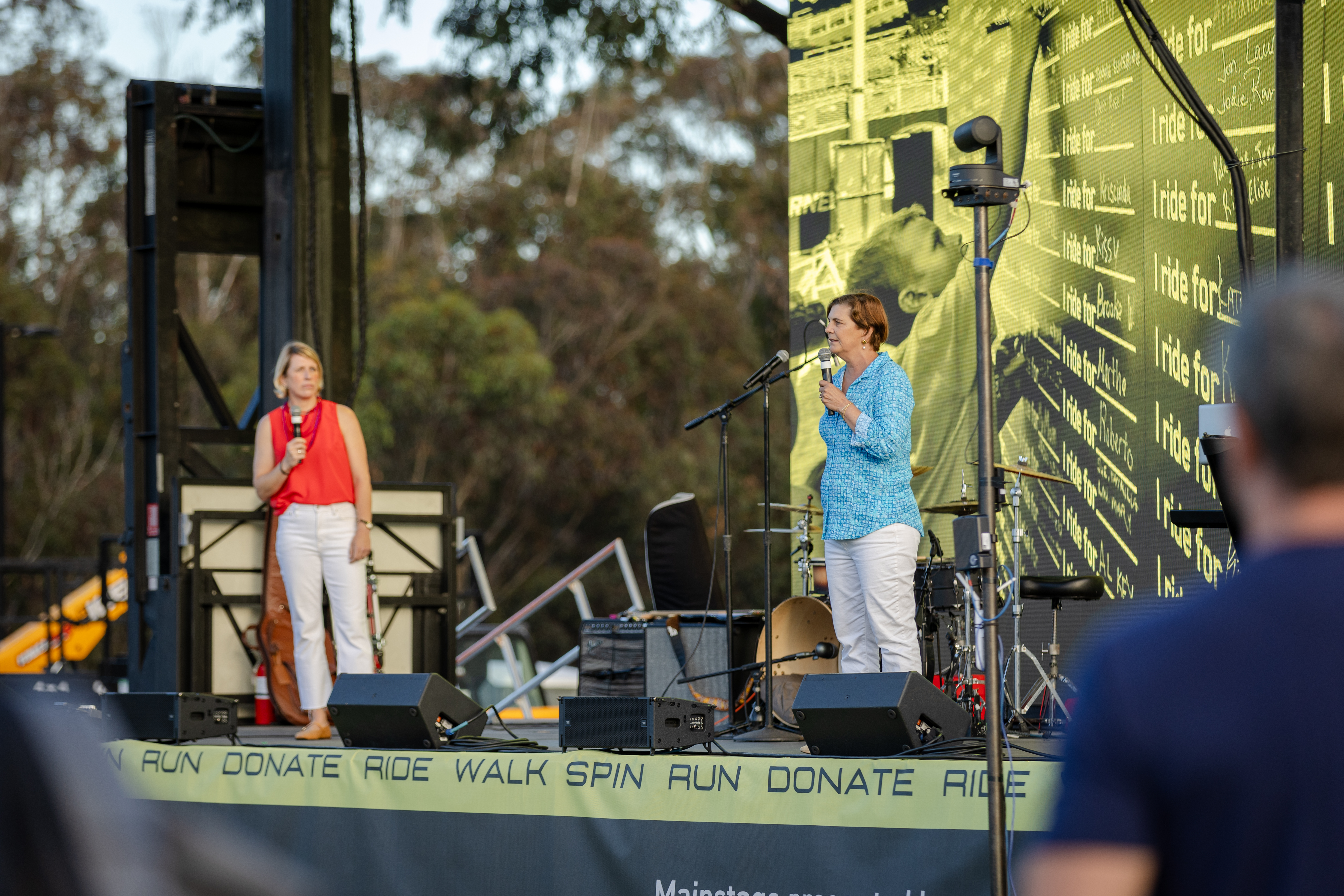 Two people speak on stage