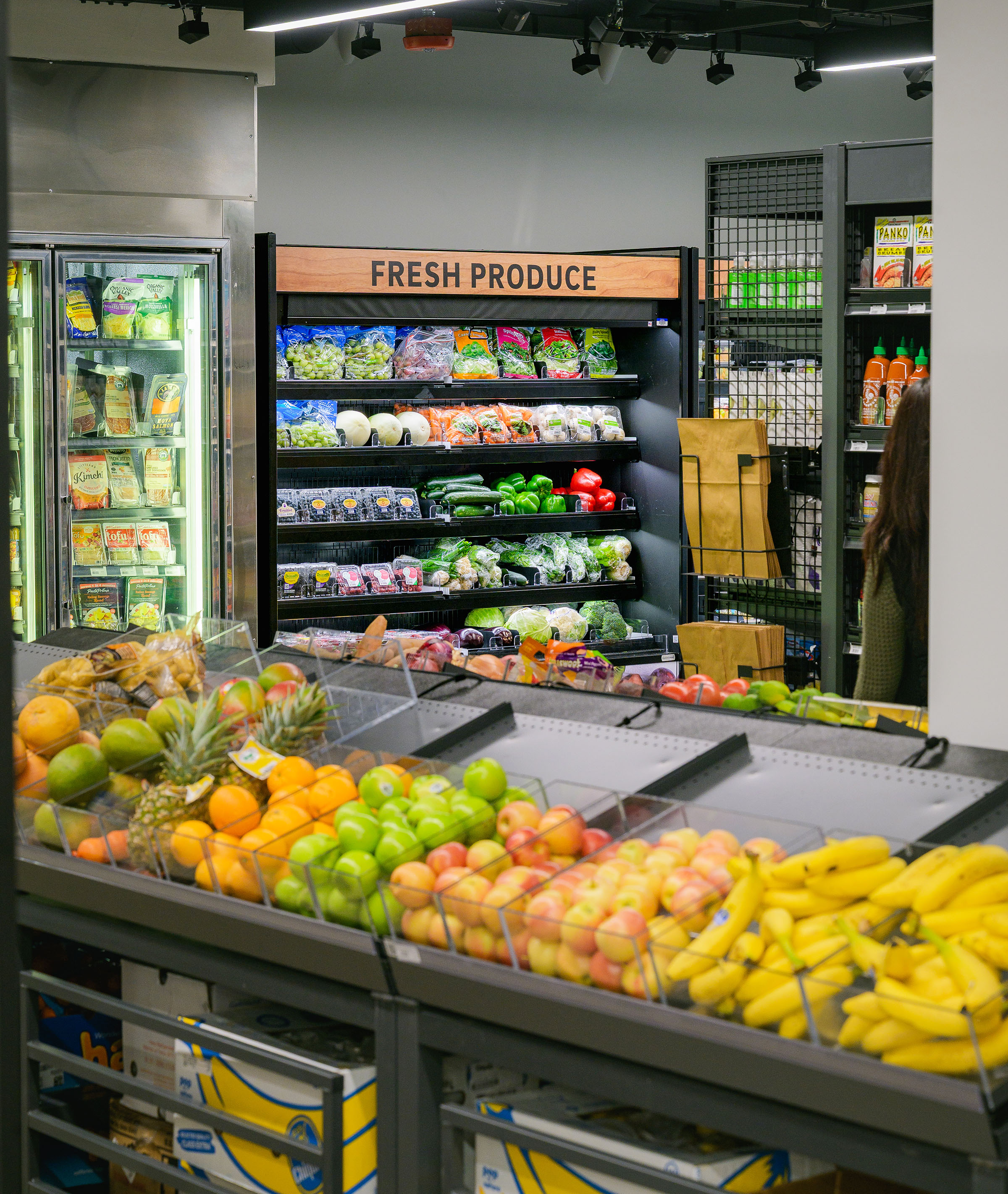 bananas, oranges, and apples displayed in store produce shelves