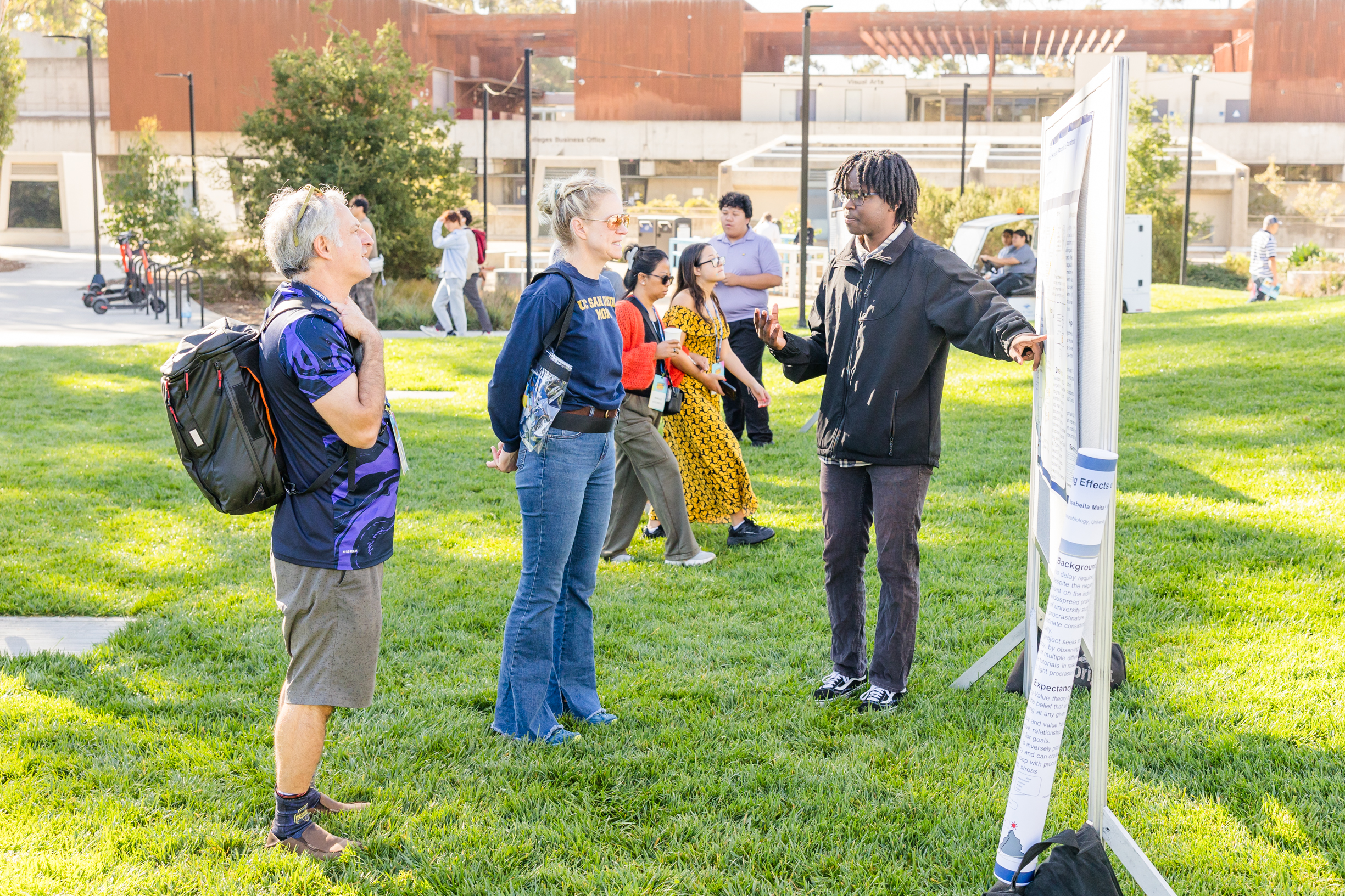 A student talks to a group about their research. 