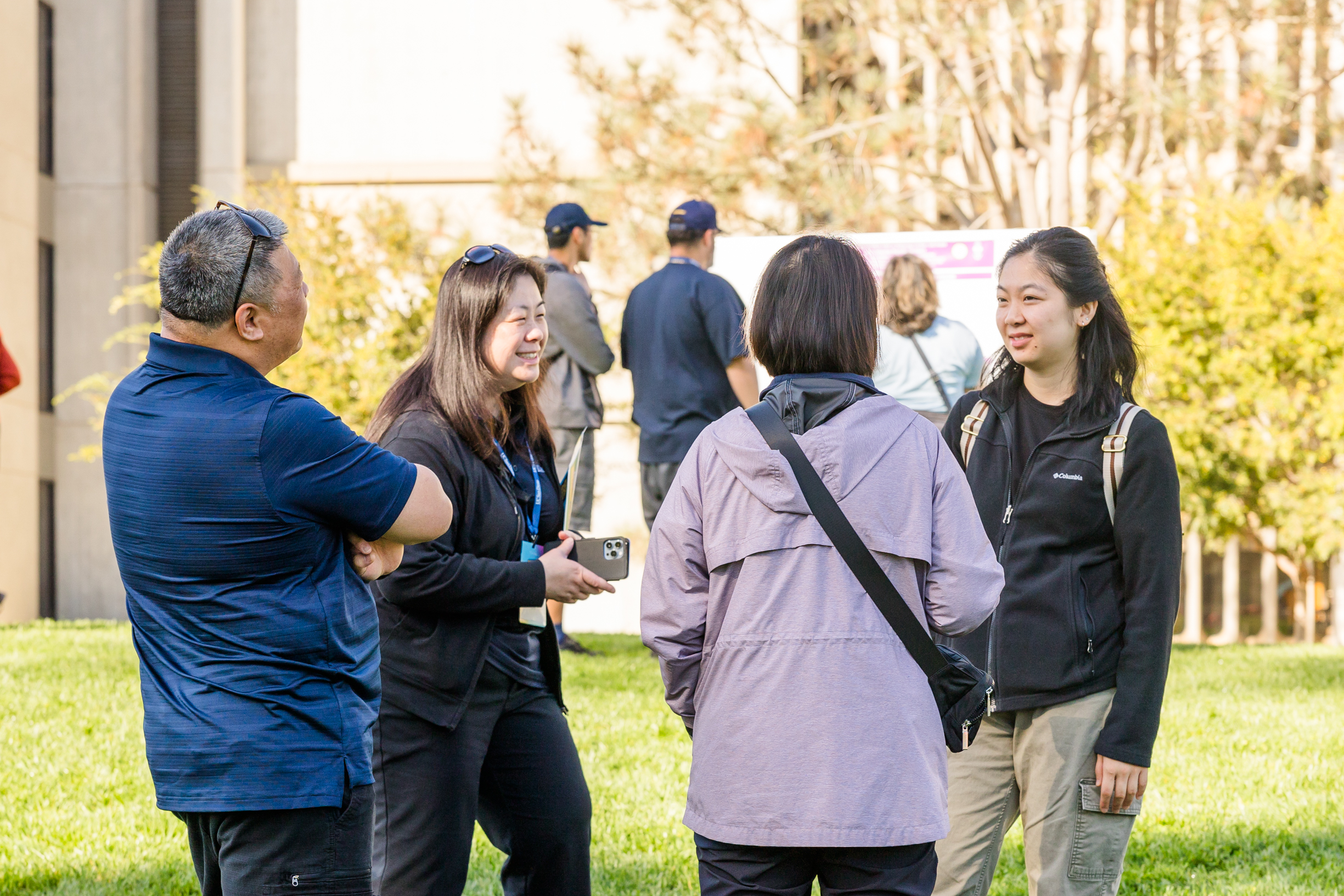 Four people converse.