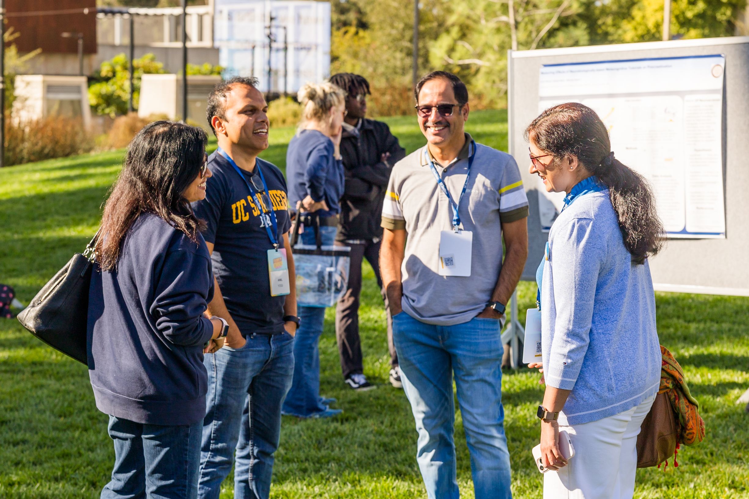 Four people converse with one another