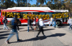 Slideshow: A red MTS bus with UPASS 30000000 RIDES spelled out in gold balloons draped over its side