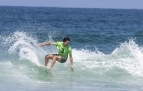 Slideshow: Surfer in green shirt on wave