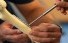 Slideshow: Close up photo of student using tools to place  a rod on a mock bone