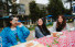 Slideshow: Three students laugh at a table