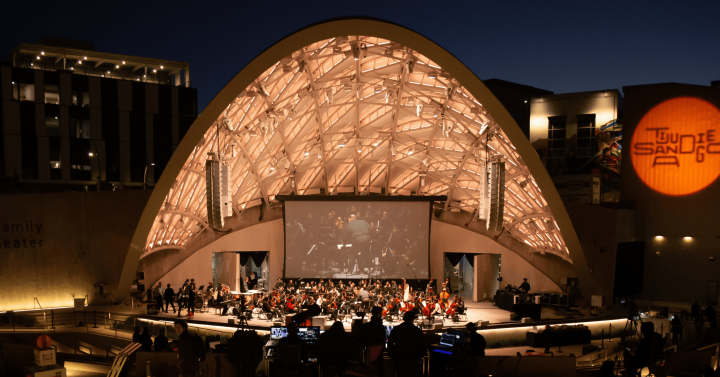 Slideshow: Epstein Family Amphitheater with musicians performing on stage.