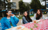 Slideshow: Three students laugh at a table