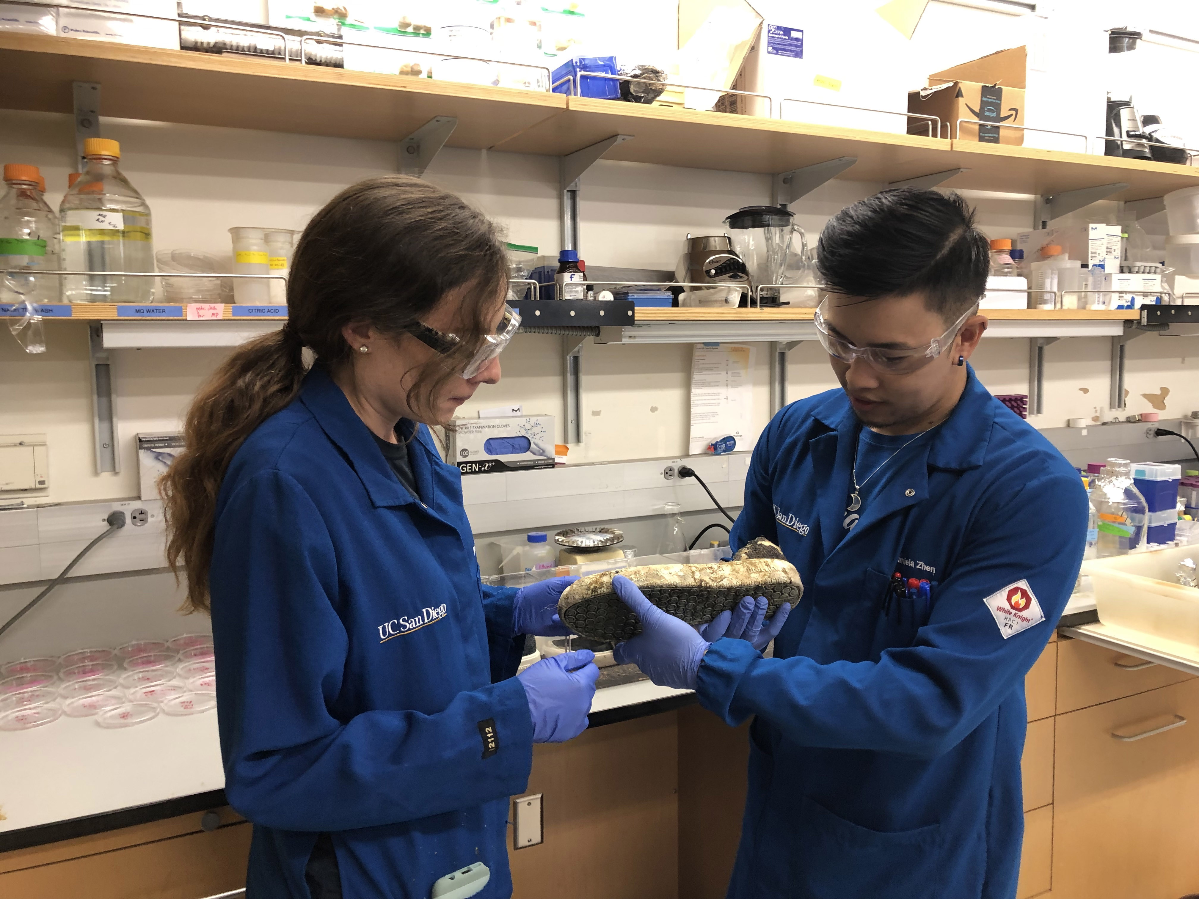 Marissa Tessman and Daniel Zhen analyze a biodegraded shoe.