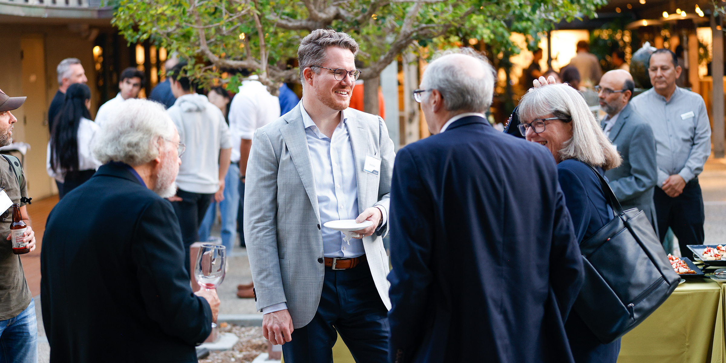 group of men talking at reception