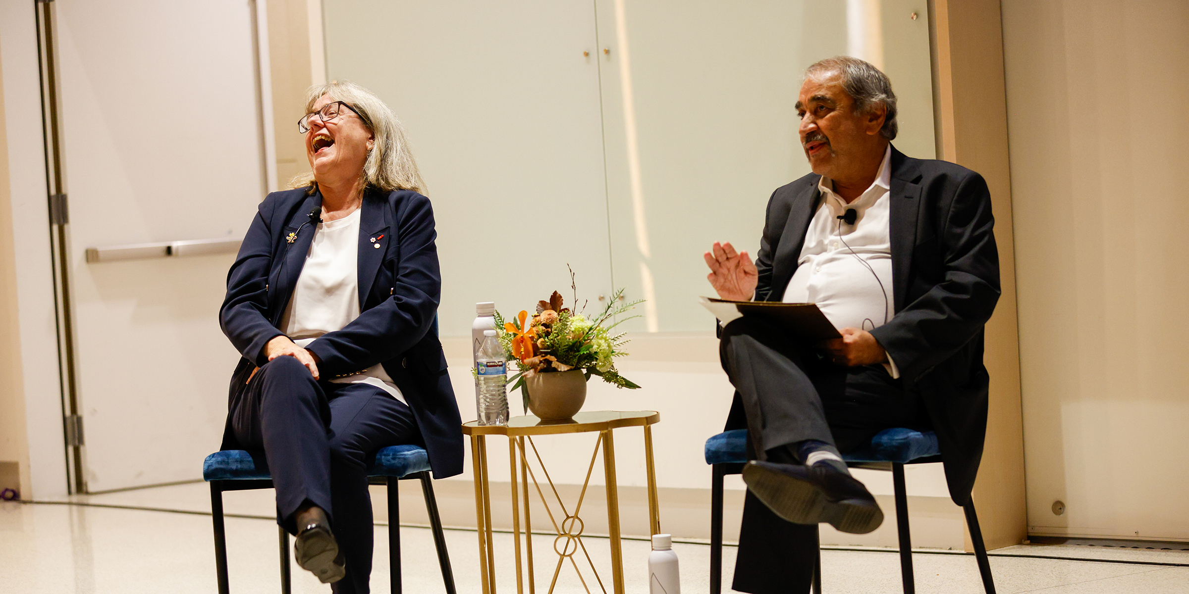 Strickland and Khosla seated, talking on stage