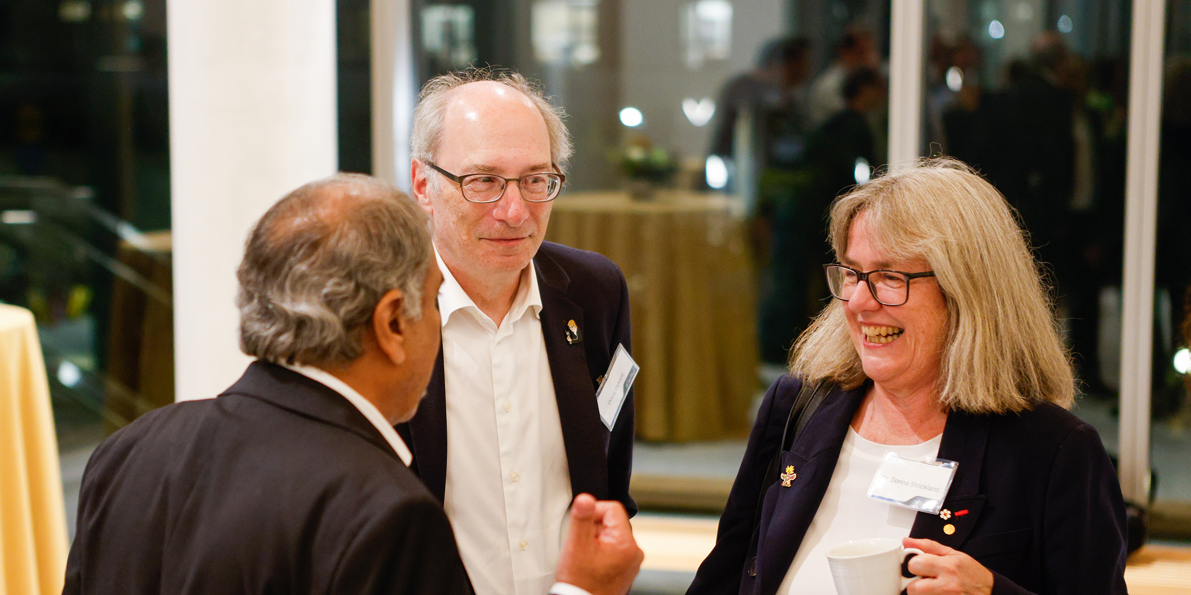 Strickland talking with others at dessert reception.