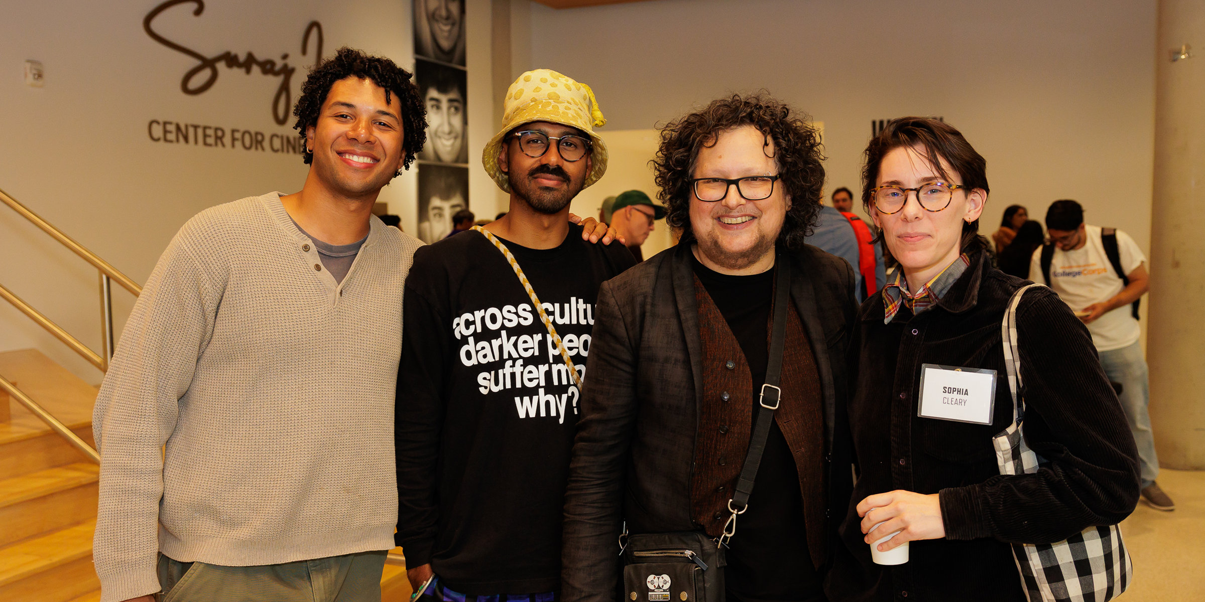 Three fellows pose with center director Michael Trigilio.