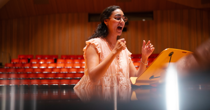Mariana Flores Bucio singing passionately during rehearsal